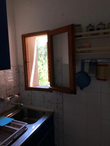a kitchen with a sink and a window at Ćetković 1 in Petrovac na Moru