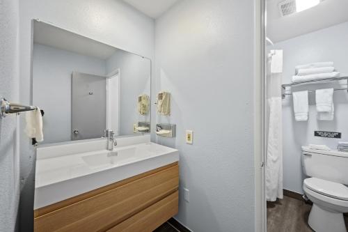 a bathroom with a sink and a toilet at Sol Springs Inn in Palm Springs