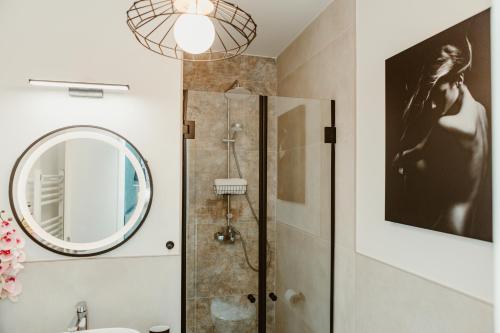 a bathroom with a shower and a mirror at ARINI WHITE HOUSE in Sibiu