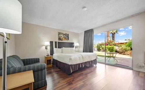 a hotel room with a bed and a couch at Sol Springs Inn in Palm Springs