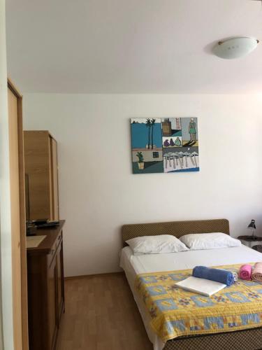 a bedroom with a bed with a table and a cabinet at Ćetković 1 in Petrovac na Moru