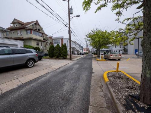 an empty street with cars parked on the side of the road at Trendy 1BD Balcony Pool Small fam or couples stay in Ocean City