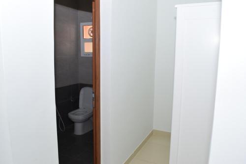 a bathroom with a toilet in a room at RED-36 - Al Mareekhy Villas in Salalah