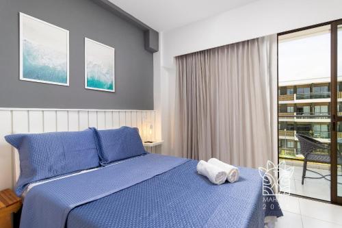 Giường trong phòng chung tại Estúdio Aconchegante Com Vista para Piscina