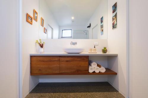 a bathroom with a sink and a mirror at Countryview Haven in Tasman