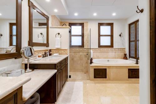 a large bathroom with a tub and a sink at 3BD Golf Front Beach Club and Hot Tub in PLC in San José del Cabo