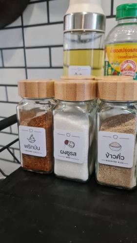 three jars filled with different types of spices at บ้านเซฟโซน in Ban Nong Hin
