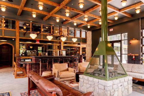 a lobby with a fireplace and a bar at The Ozarker Lodge in Branson