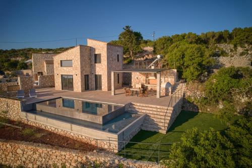 an aerial view of a house with a swimming pool at Aroa Eco Living Experience in Volimes