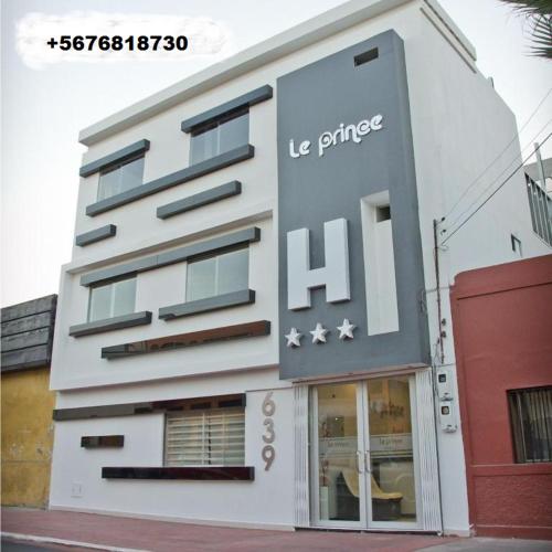 a white building with a us prime sign on it at Le Prince Arica in Arica