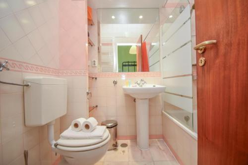 a bathroom with a toilet and a sink at Cozy and Family apartment in Lisbon