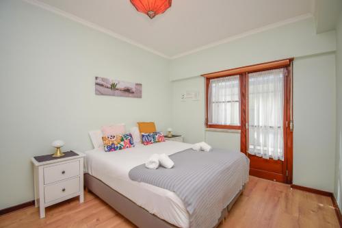 a bedroom with a bed and a window at Cozy and Family apartment in Lisbon