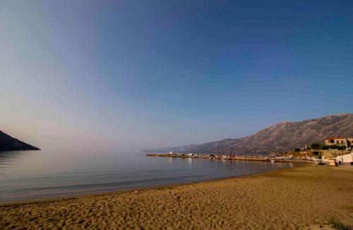 a view of a beach with mountains in the background at Laconian Collection Kotronas Residence in Kotronas