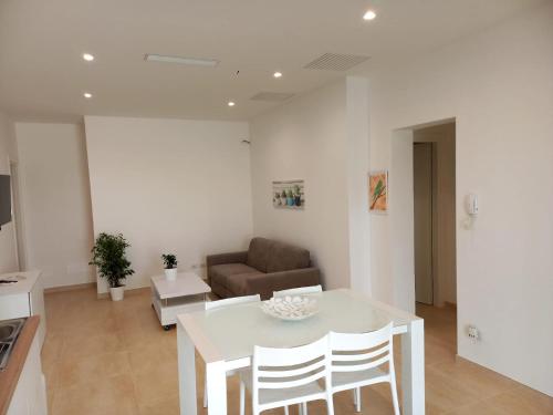 a living room with a table and a couch at SALENTO AT HOME in Nardò