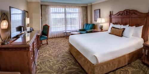 a hotel room with a large bed and a desk at Rosen Shingle Creek Universal Blvd in Orlando