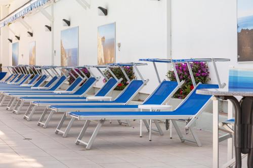 a row of blue and white chairs in a building at Best Western Hotel La Solara in Sorrento