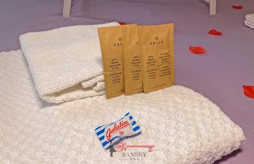 a pile of white towels on a table with a packet of milk at Violet Suite 5 Lugano City for 4 Guest -By EasyLife Swiss in Lugano