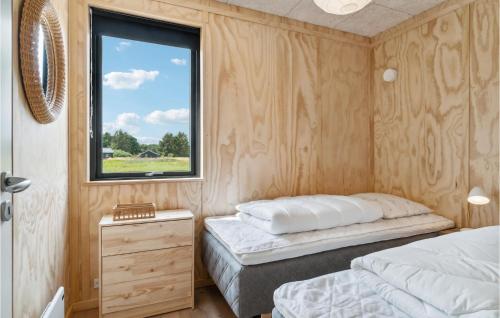 a bedroom with two beds and a window at Gorgeous Home In Grenaa With Kitchen in Brøndstrup