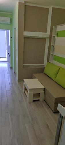 a living room with a couch and a coffee table at Cinema House Single & Double Rooms & Studio Apartments in Pula