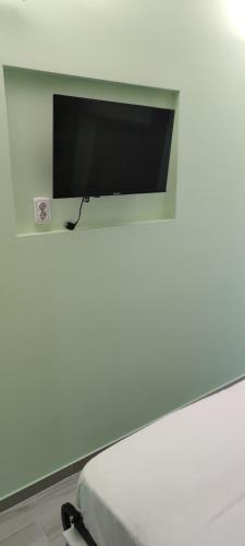 a flat screen tv sitting on a white wall at Cinema House Single & Double Rooms & Studio Apartments in Pula