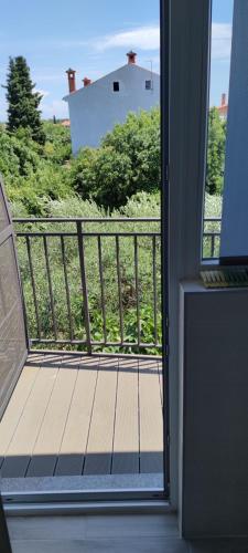 a balcony with a view of a house at Cinema House Single & Double Rooms & Studio Apartments in Pula