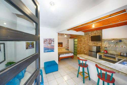 a kitchen with two red chairs in a room at New Sayulita One-Bedroom in Great Location Near Everything in Sayulita