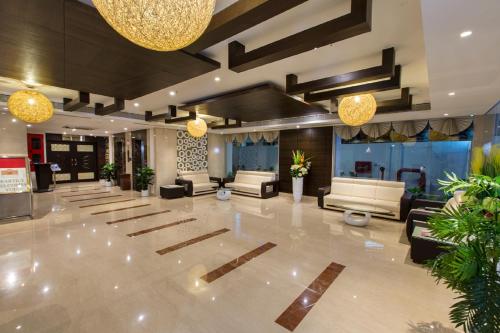 a large lobby with couches and tables and lights at Pai Viceroy in Tirupati