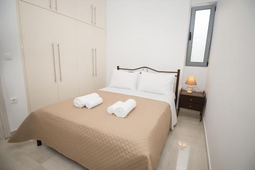a bedroom with a bed with two towels on it at Vonitsa Luxury Apartments in Vonitsa