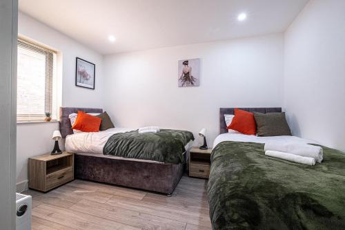 a bedroom with two beds and a window at 7 Guests - 4 Bedroom - Free Wi-Fi - Kettering in Kettering