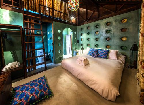 a bedroom with a bed with a stuffed animal on it at Siamotif Boutique Hotel in Bangkok