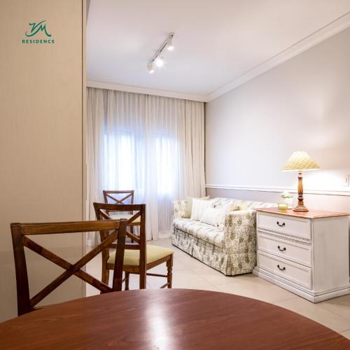 a living room with a couch and a table at Hotel Villa Morra Suites in Asuncion
