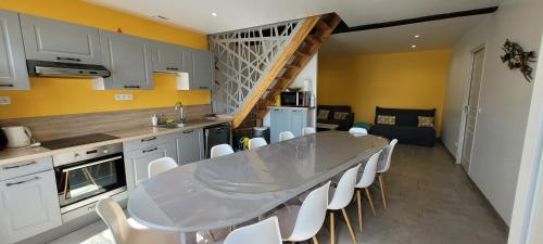 a kitchen with a table and chairs and a staircase at La Graine de Beurre proche zoo de Beauval in Seigy