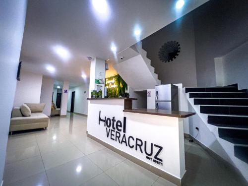 a lobby with a hotel verreasy sign and stairs at Hotel Boutique Veracruz termales in Santa Rosa de Cabal