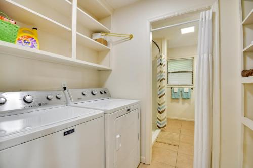 a white laundry room with a washer and dryer at Pet-Friendly Cabin with Dock on Lake Martin! in Jacksons Gap
