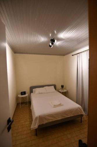 a bedroom with a bed and two side tables at Cozy Paradise in Preveza