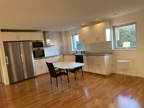 a kitchen with a table and chairs in a room at Kulladal Malmö in Malmö