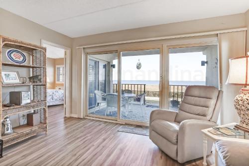 a living room with a couch and a chair at Atlantic Ocean View Condo in Fernandina Beach