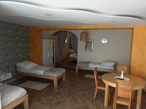 a room with two beds and a table with a table at Apartament 592 in Boguszów-Gorce