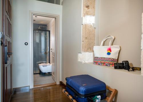 a room with luggage sitting on a bench in a hallway at Mosaic Venetian Harbour Suites in Chania