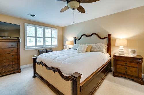 a bedroom with a large bed and a ceiling fan at Roomy Martinsville Vacation Rental with Private Deck in Martinsville
