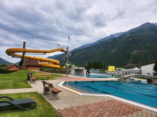 a resort with a pool and a water slide at Apartment Ad Alta Obervellach in Obervellach
