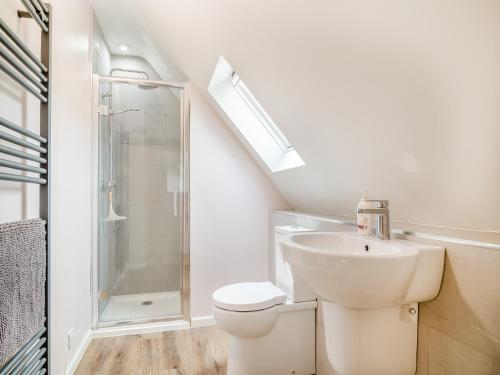 a bathroom with a toilet and a sink and a shower at The Old Stable At Henley View in Draycott