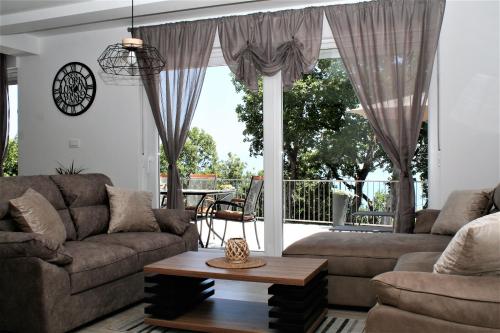 a living room with a couch and a table at Holiday house Jovich in Martina