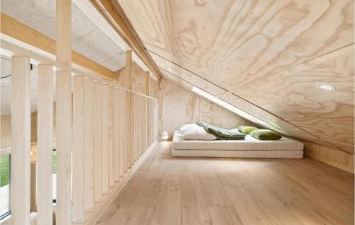 a bedroom with a bed in the middle of a room at Gorgeous Home In Grenaa With Kitchen in Brøndstrup