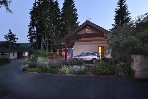 a car parked in front of a house at Rekreační domek Kobylnice Lipno in Lipno nad Vltavou