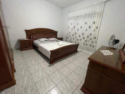 a bedroom with a bed and a dresser and a dresser at Albert Guest House in Borsh