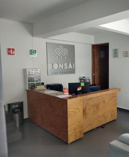 an office with a counter with a sign on the wall at Bonsai Las Aguilas in Mexico City
