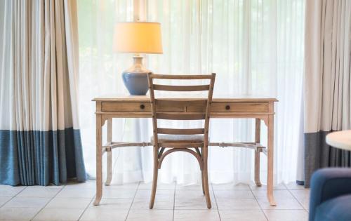 a wooden desk with a chair and a lamp on it at The Villages at Ocean Edge Resort & Golf Club in Brewster