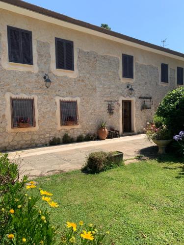 a large stone building with windows and a courtyard at COUNTRY HOUSE in Sezze