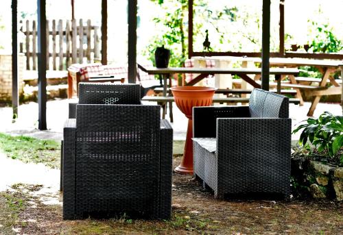 a group of wicker chairs sitting in front of a table at COUNTRY HOUSE in Sezze